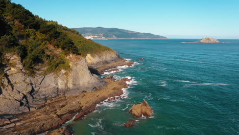 Aerial-drone-shot-of-a-rocky-coastline-by-the-Mediterranean-sea