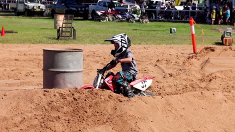 motorcyclist performing turns on a sandy course