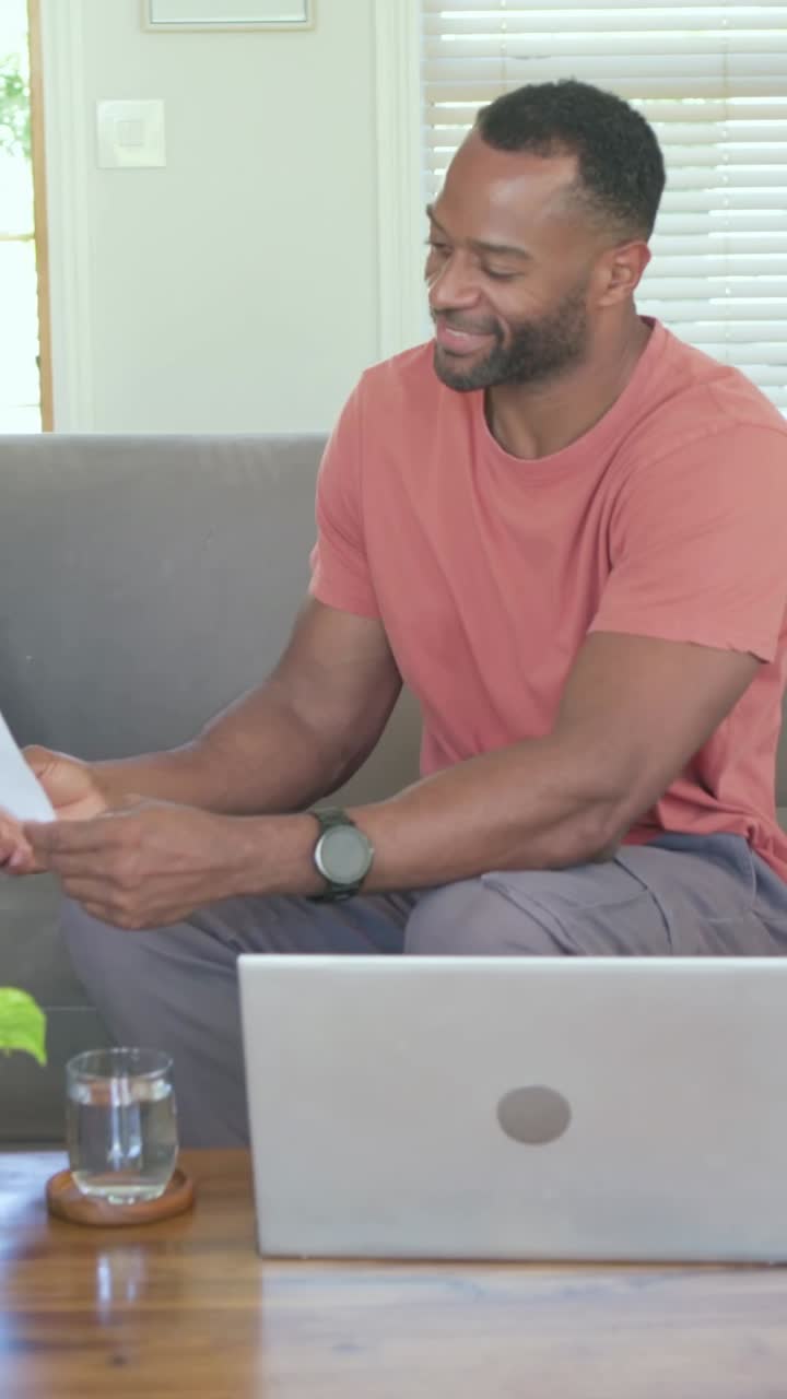 Vertical video: Smiling dad turning from laptop at home as yellow boy entering checking backpack