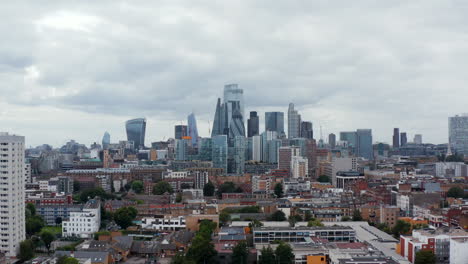 Panoramic-view-of-group-of-tall-modern-office-buildings-in-City-financial-hub.-Backwards-reveal-of-apartment-building.-London,-UK