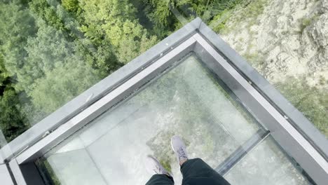 person looking down on viewing platform with glass floor in germany