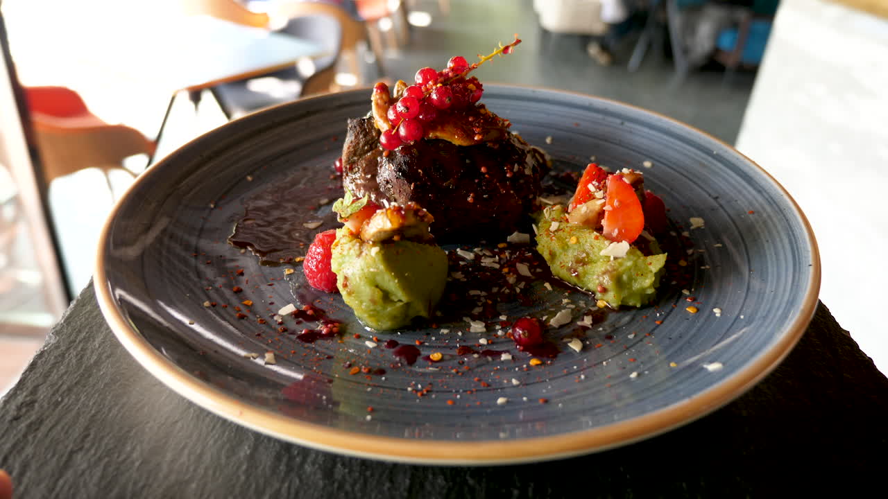 Steak with avocado and red currants