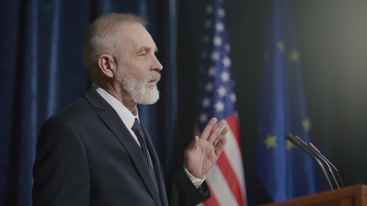 Senior Male Diplomat Answering Questions from Audience at Global Summit