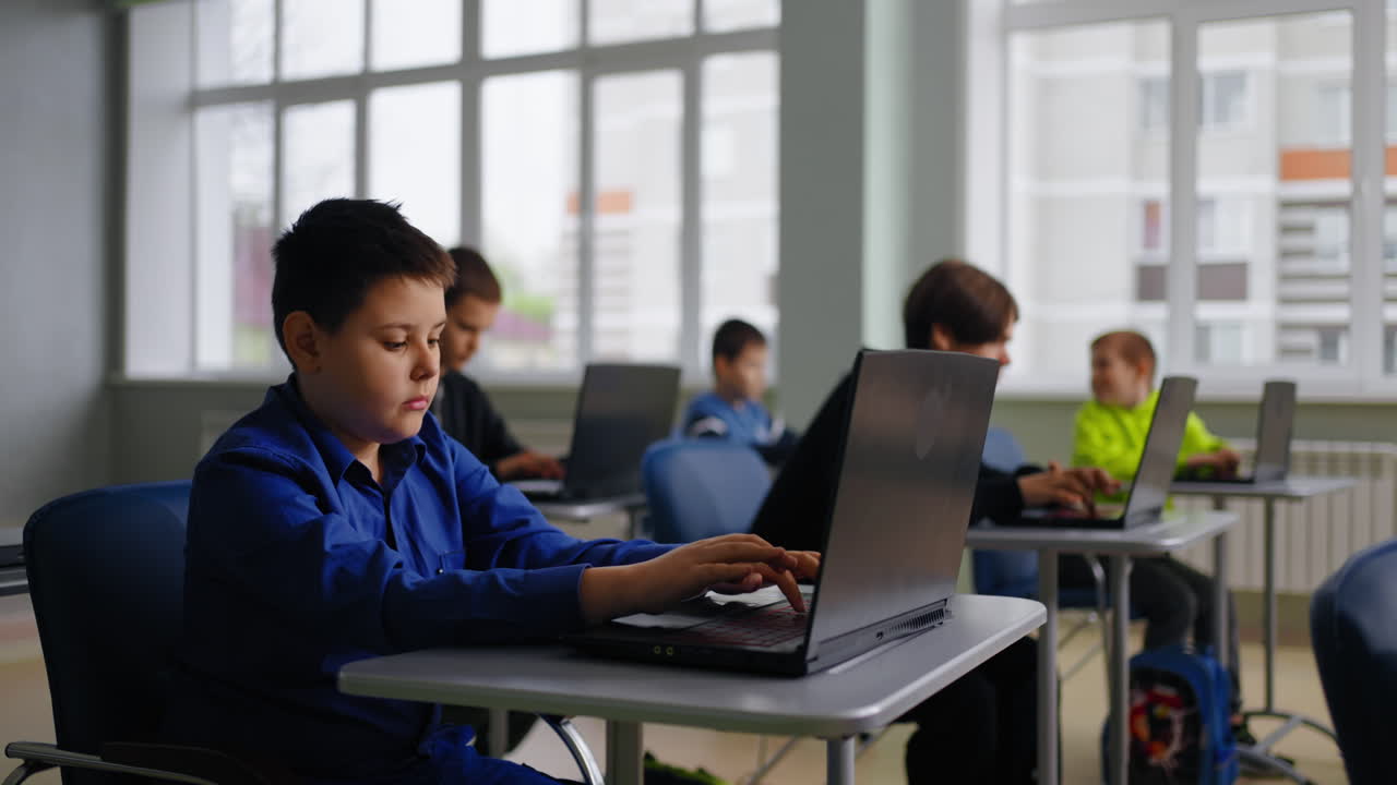 Students using laptops in a classroom setting