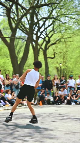 New York, USA, 8 July 2025: Street performers shine in NYC. In Central Park, talented street performers dazzle a lively crowd with acrobatic tricks on a sunny day in New York