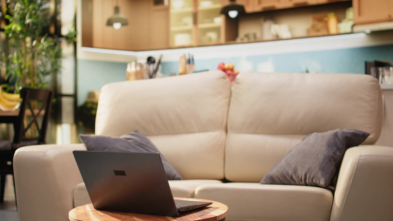 Living room interior with laptop placed on round coffee table