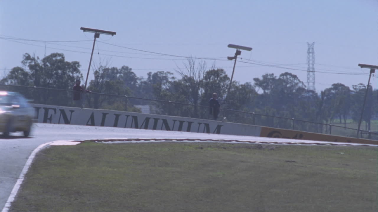 경주용 자동차가 경마장을 돌고 있습니다.