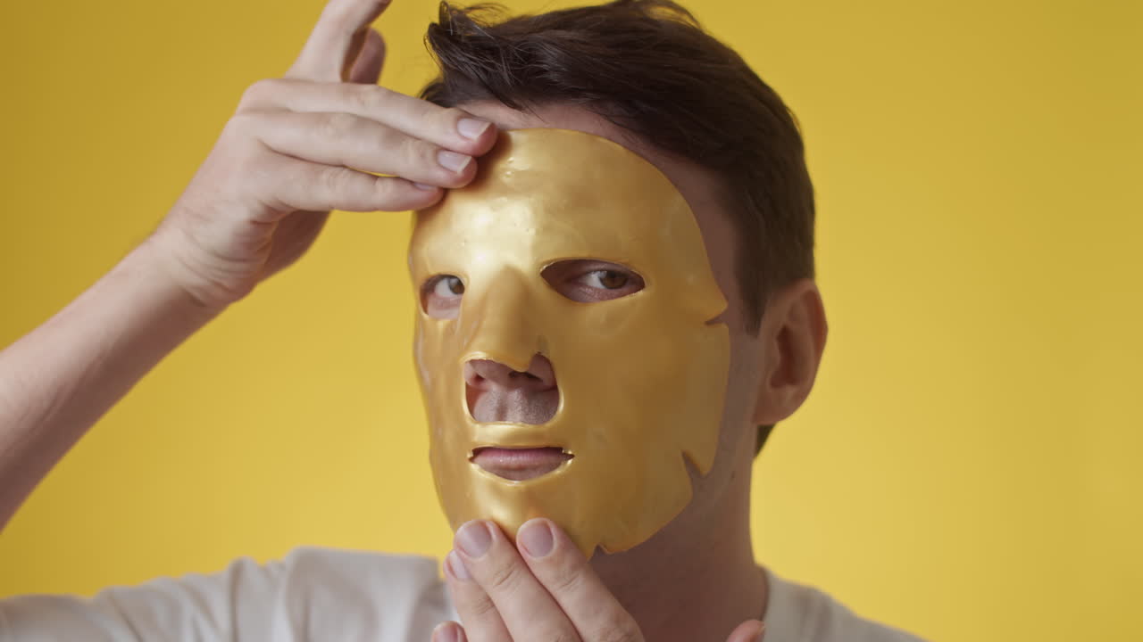 Man Wearing Golden Sheet Mask on Face
