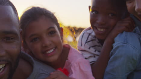 happy black family embracing outdoors, close up