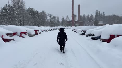 Girl-walking-down-a-snowed-in-parking-lot