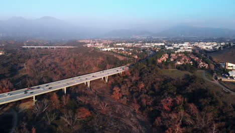 aerial rotation over a bridge at sunset in a suburban city angle 2