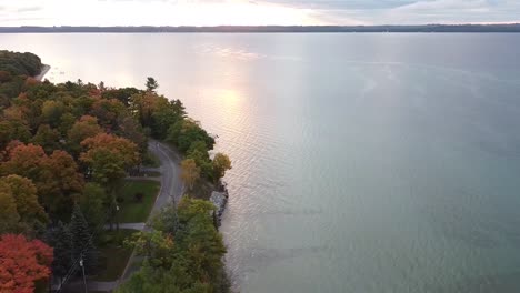 tarcking drone shot of lake michigan coastal shoreline during autumn