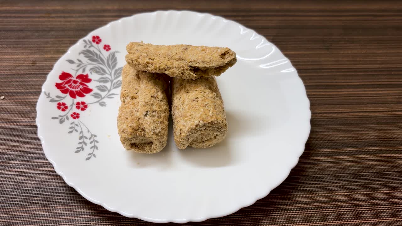 traditional indian sweets sesame brittle or tilkut served on white ceramic plate top view