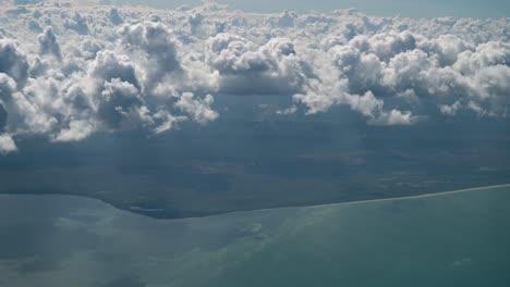 viewing the clouds and coast of cancun mexico from an airplane, aerial