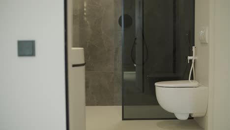 modern bathroom with wall-mounted toilet and gray tile design