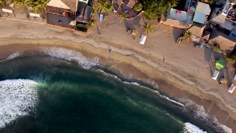 top-down aerial passive drone shot of sayulita beach in mexico during golden sunset hours