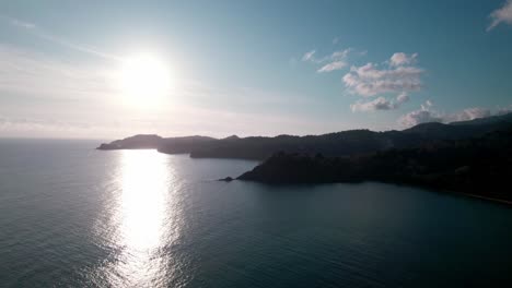 Overview-of-different-islets-from-island-in-the-ocean,-surrounded-by-rainforest,-aerial