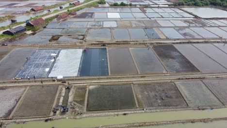 Aerial-drone-view-of-the-vast-expanse-of-salt-ponds-at-seaside-area-in-Jepara,-Central-Java,-Indonesia