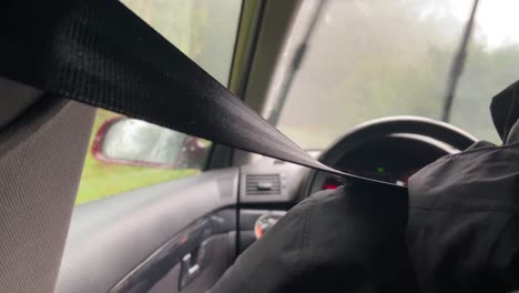 view behind person driving car in rainy day with wind screen wipers on