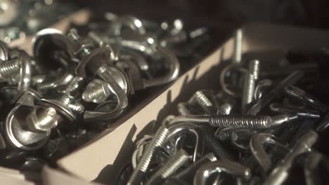 Close-up view of hooks with screws, captured in slow motion