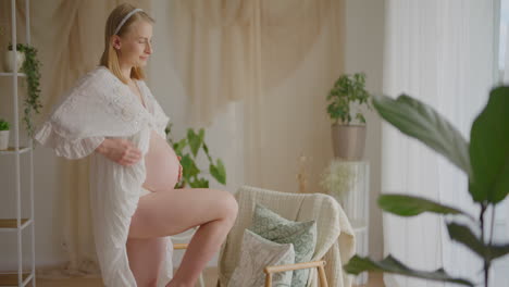 Pregnant Woman in Elegant Living Room Embracing Belly