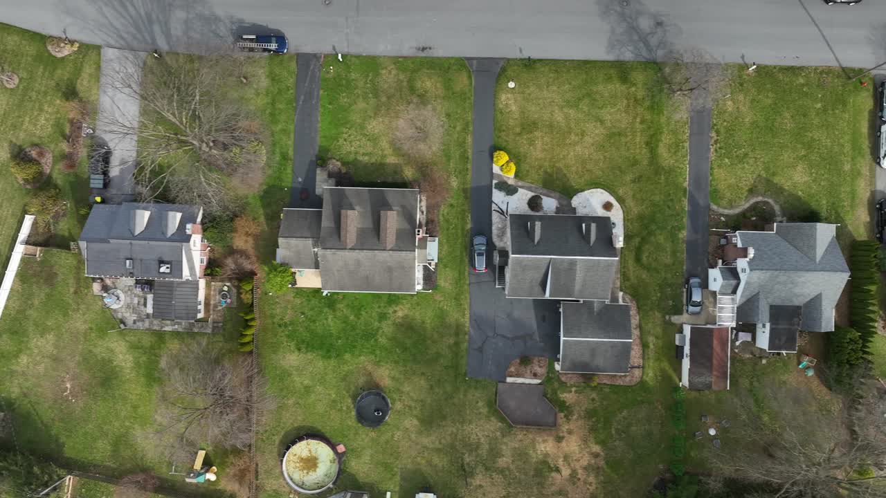 Luxury houses with swimming pool in american neighborhood. Sunny day in spring season. Aerial top down flyover.