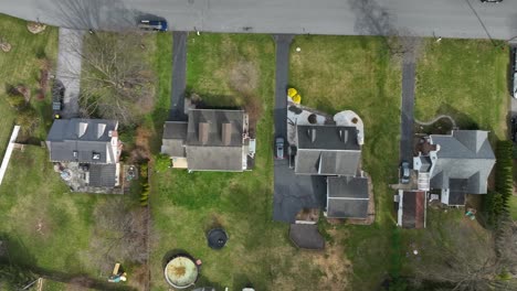 luxury houses with swimming pool in american neighborhood. sunny day in spring season. aerial top down flyover.