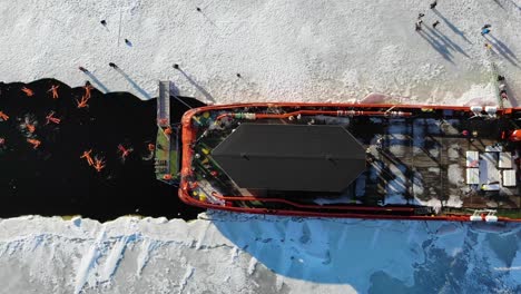 ice breaker ship - ice breaker workers relaxing and swimming on frozen water in lapland finland aerial top-down
