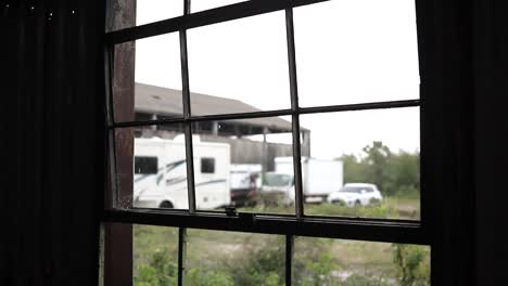 video shot from the window of an old abandoned warehouse, rainy and cloudy day, hd video