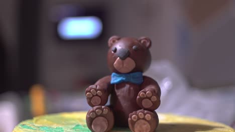 tilt down footage of brown bear made of sugar paste fondant, close up 4k isolated shallow depth of field homemade