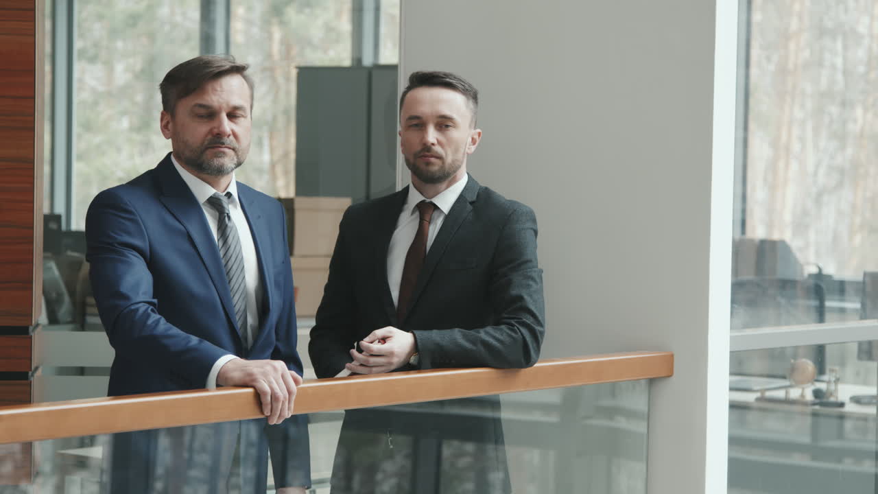 Portrait of Two Serious Male Lawyers in Suits