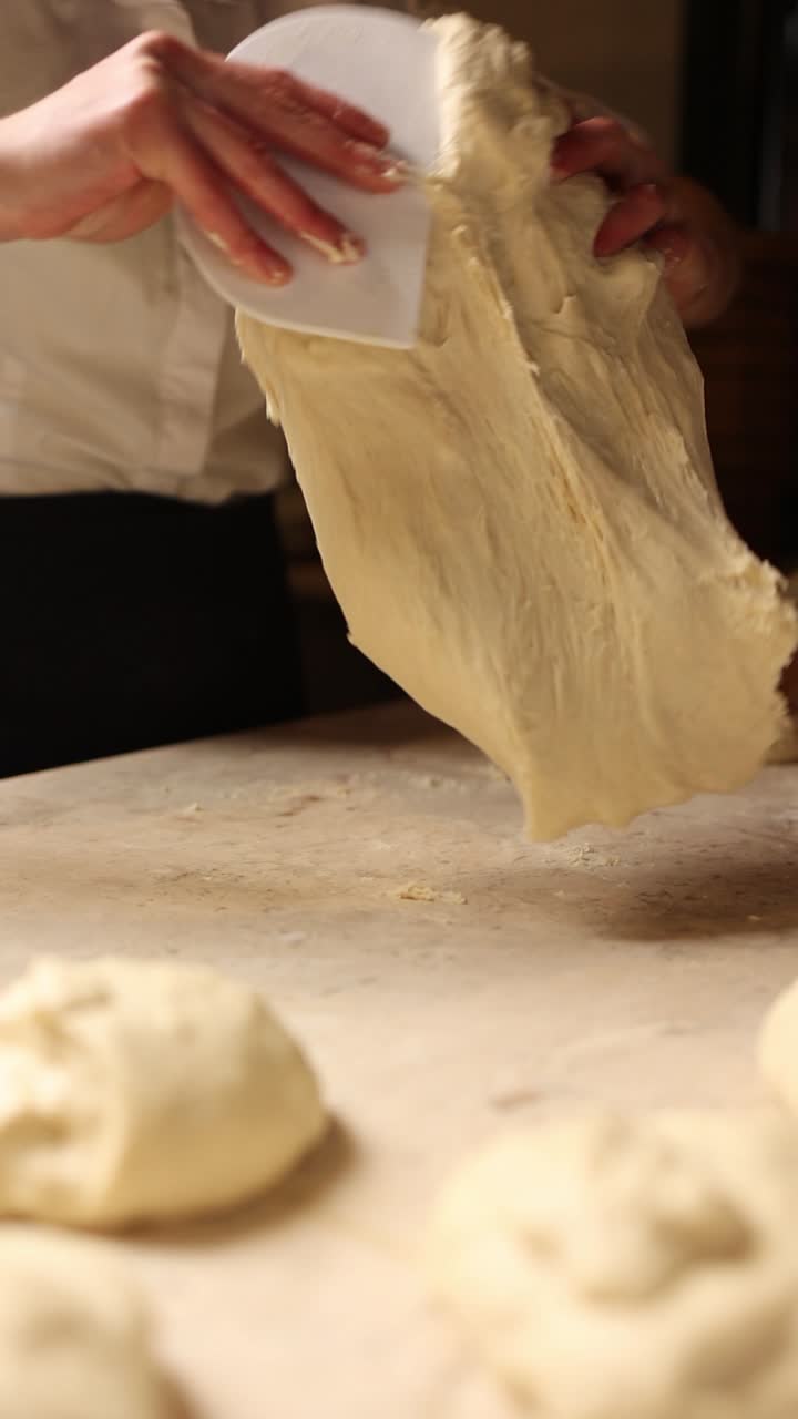 A baker shaping dough