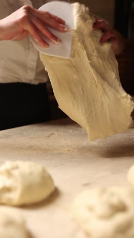 a baker shaping dough