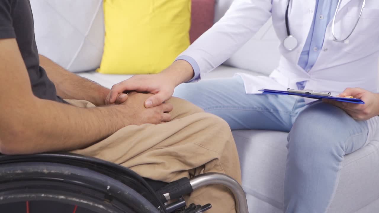 Hands of doctor giving morale to disabled patient in slow motion.