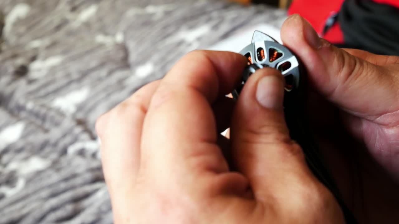 Male hands tighten hobby drone motor onto carbon fibre frame testing strength