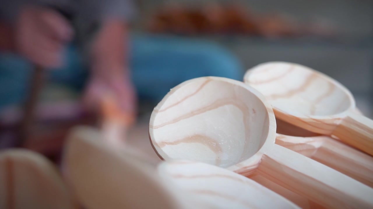 A unique craftsman making a handmade vintage wood spoon for cooking. 
A cultural traditional old way of carpentry, transforming wood in objects, all by hand and with primary tools.