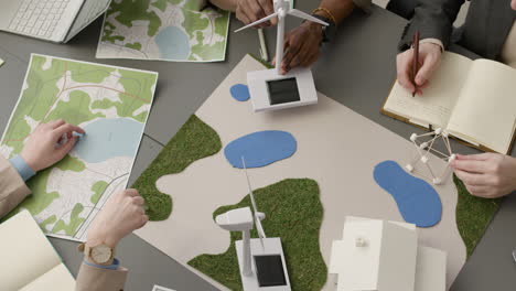 top view of a multiethnic business team discussing about renewable energy project in the office