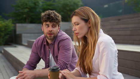 friends couple resting together in urban park closeup. beautiful woman talking