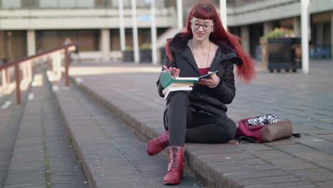 young red head hipster student has a moment of realisation whilst working on a project