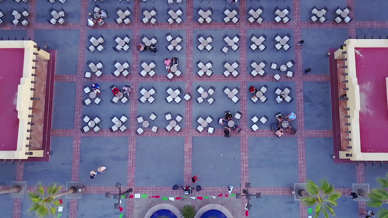 Drone shot looking down on an outdoor restaurant's table and chairs