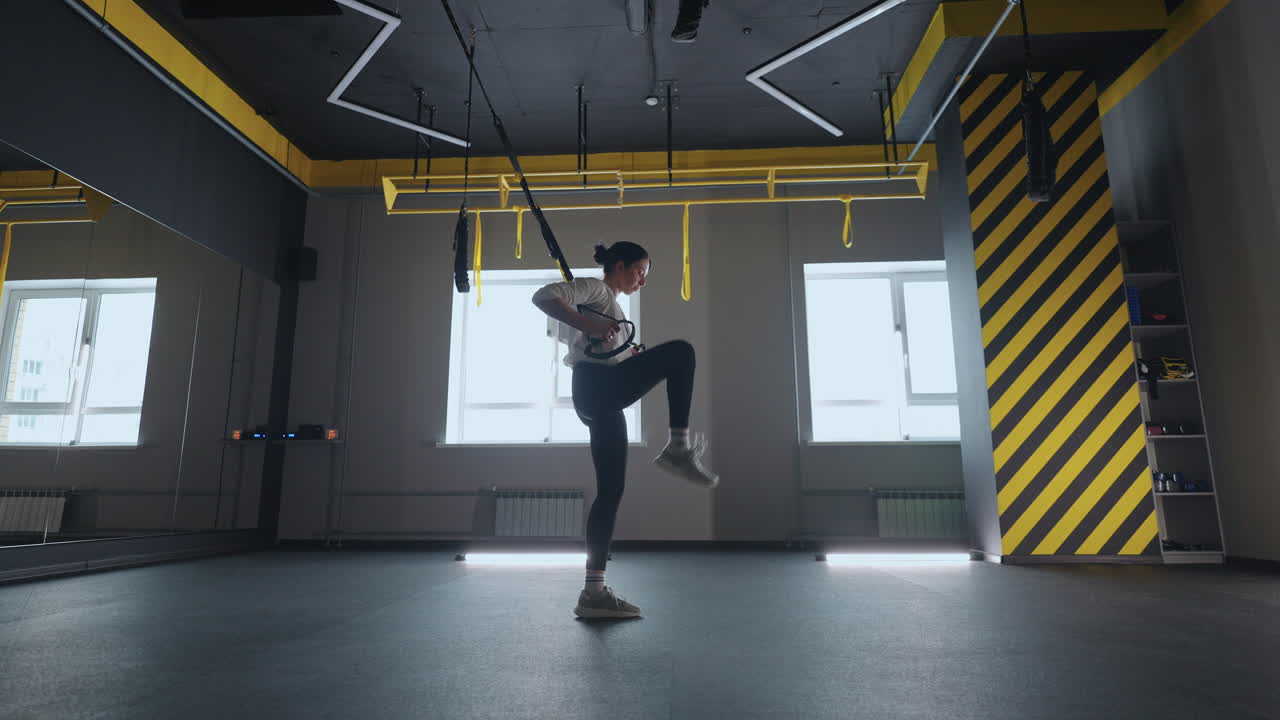mujer deportiva haciendo ejercicios de trx en el gimnasio. mujeres entrenando con correas de fitness en el gimnasio. mujer hermosa ejercitando sus músculos con correa o correas de suspensión.