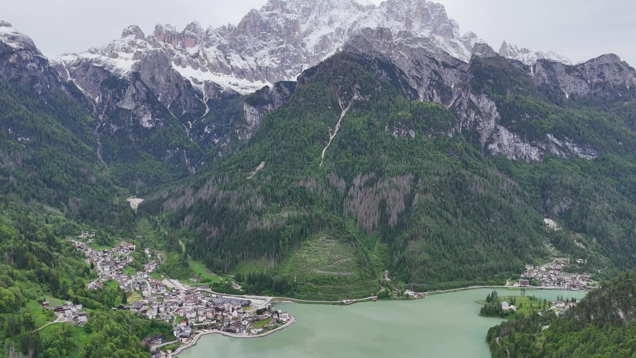 Cinematic drone push with tilt reveals Italian mountain town