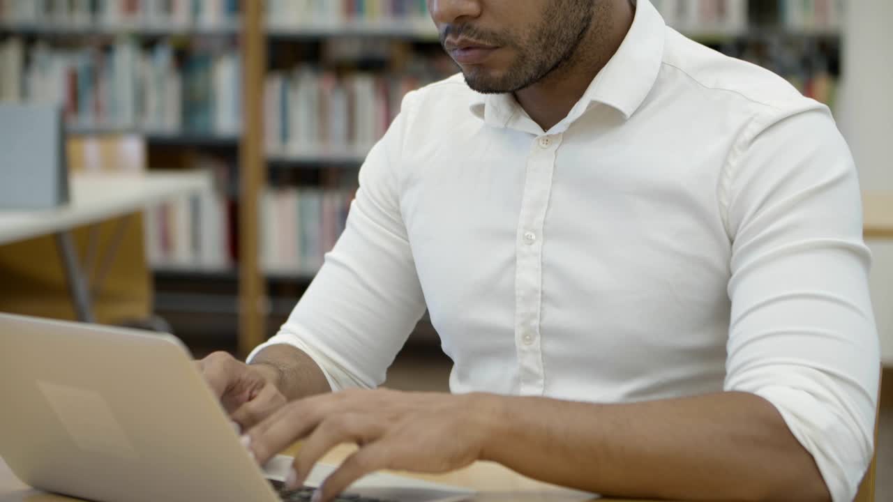estudiante afroamericano pensativo que estudia en la biblioteca