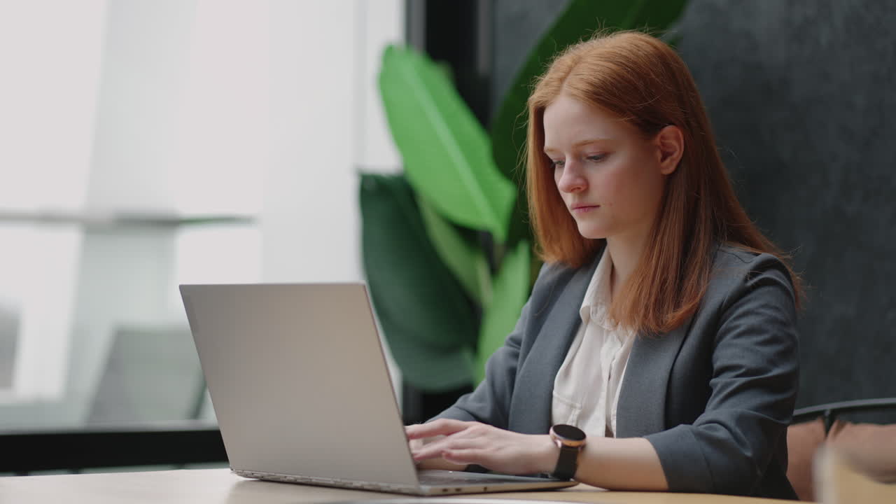 female seo specialist or lawyer is typing message on laptop and sending in work chat successful serious woman