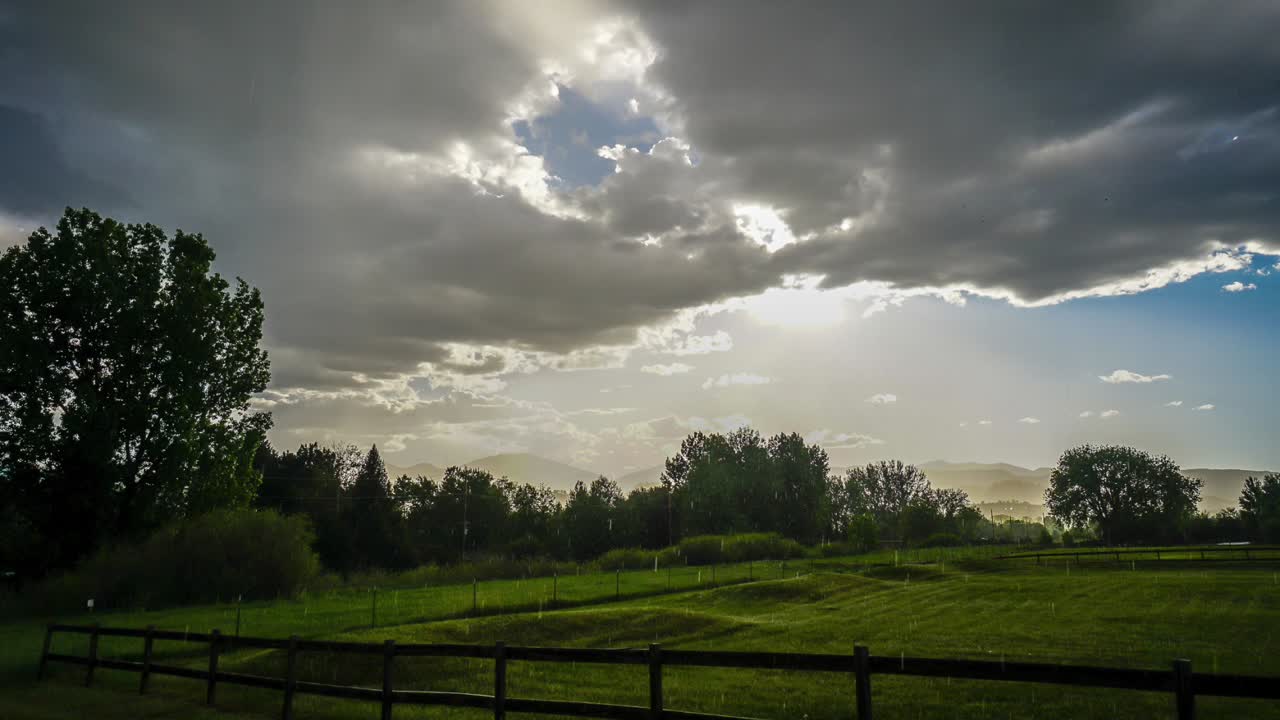 Time lapse of a rain storm as the sun breaks out and the light reflects ...