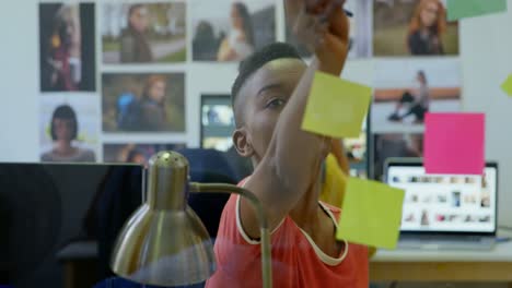 female graphic designer looking at sticky notes 4k