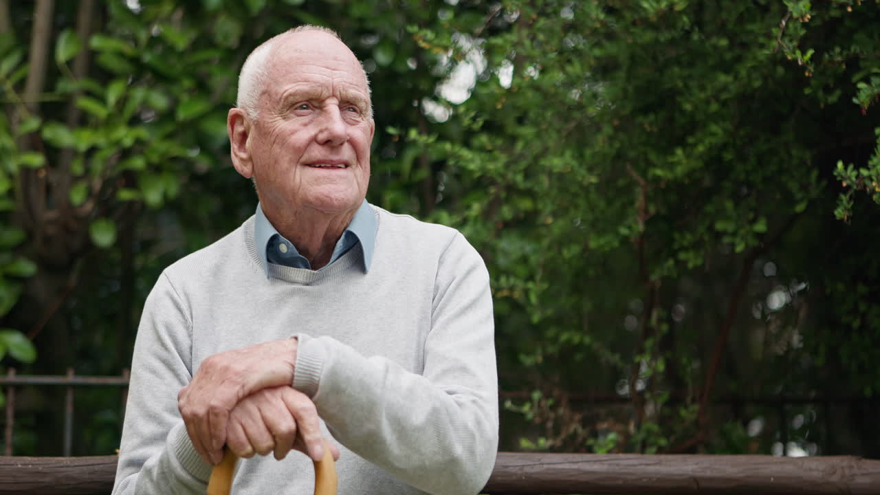 Elderly man with cane outdoors