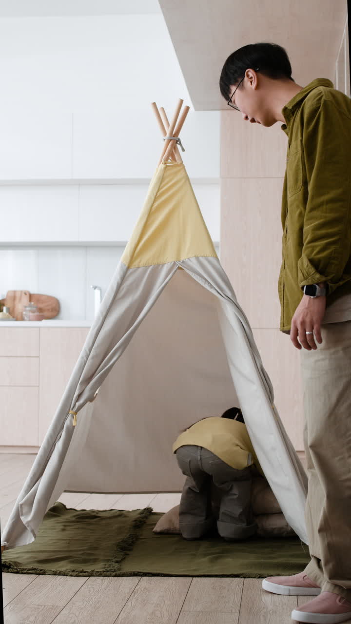 Family playtime in a teepee
