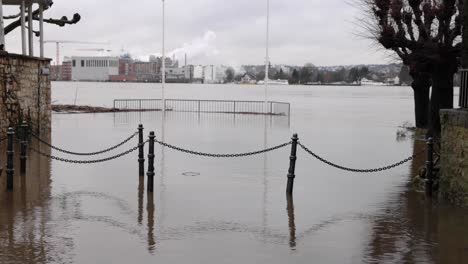 rope barrier and the town immerse in flood from rhine river, germany. wide shot