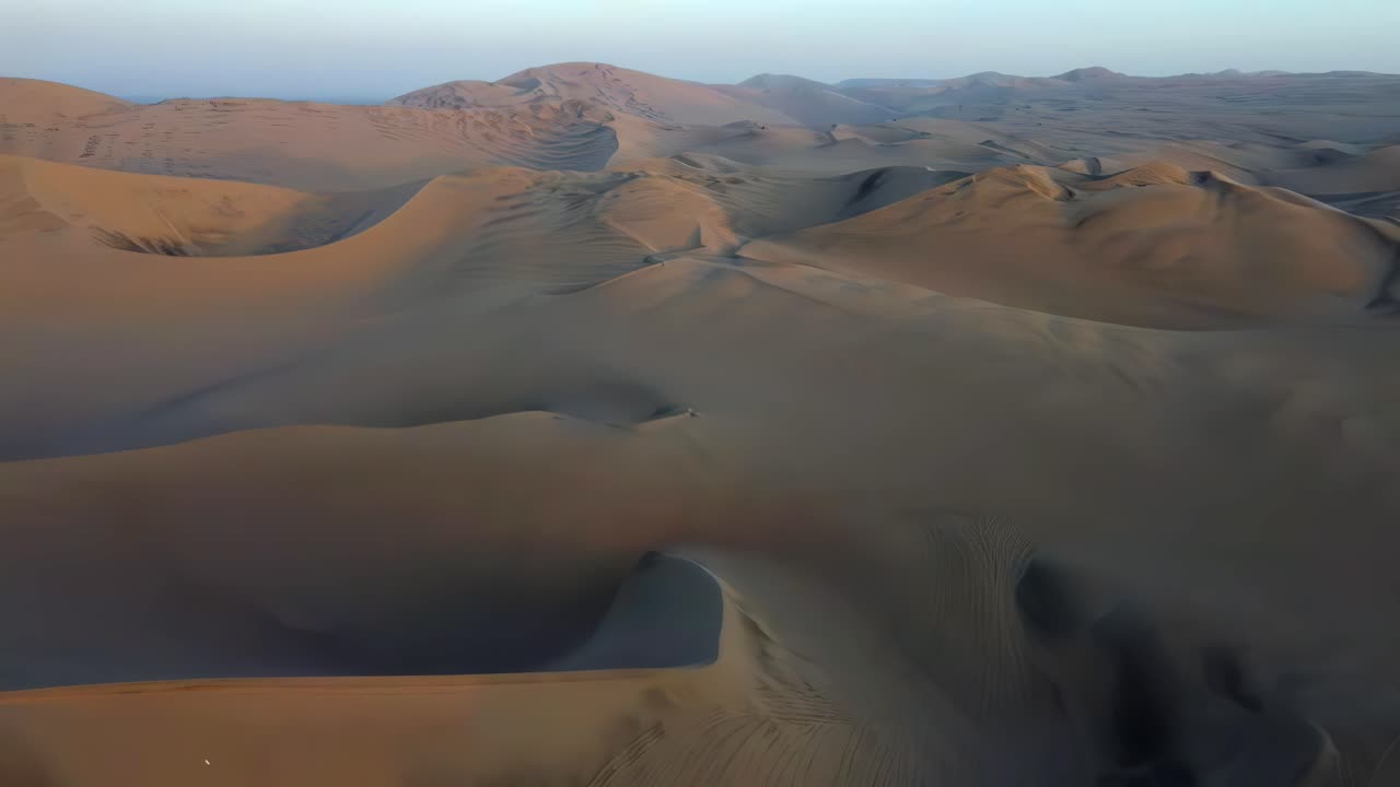 Sand dunes desert Peru South America dry land landscape aerial drone view empty